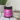 A jar of North Hound Life Skin & Coat Health + supplement placed on a white tiled surface next to a ceramic bowl and a potted plant.